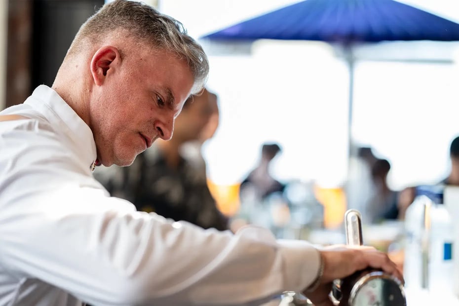 Leo preparing the refreshing Oita Sunrise, made with iichiko Saiten, passion fruit, and tomato water